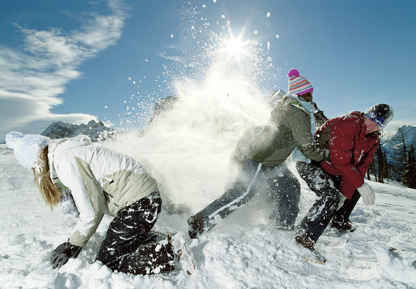 Image of students wearing winter clothes having a snowball fight