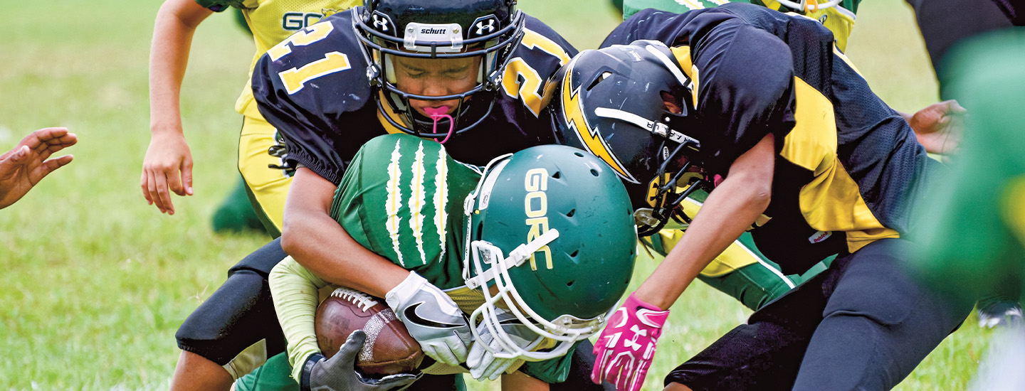 Photo of football players colliding during a game