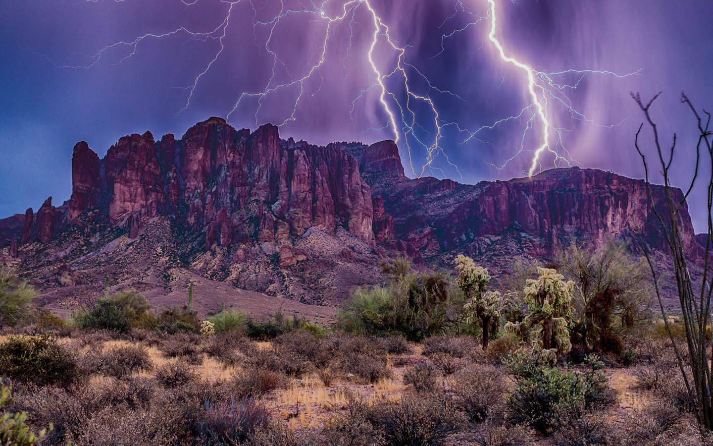 Image of lightning bolts during the desert at night